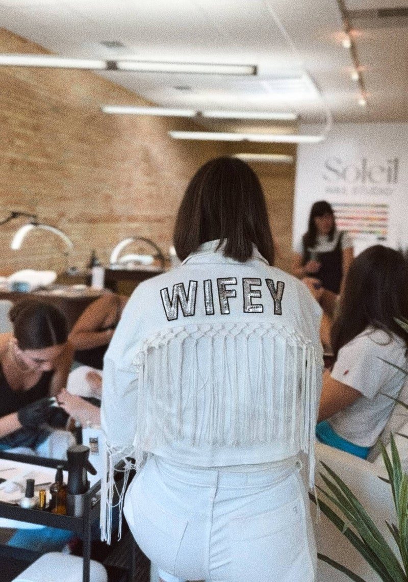 Bride in a white WIFEY jacket getting her nails done at Soleil Nail Studio
